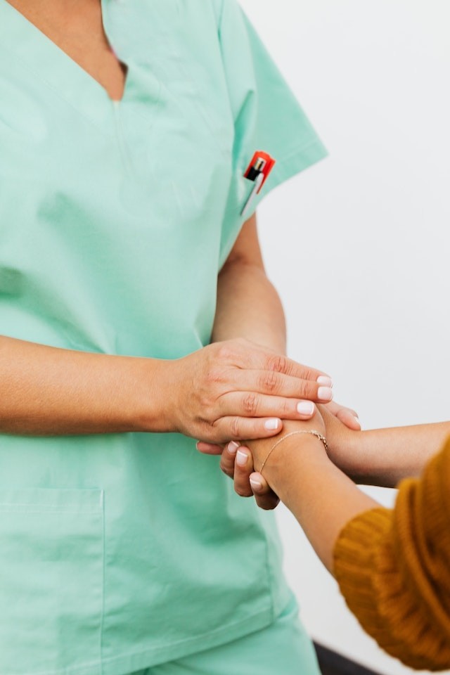 caregiver nigeria holding hands with a vulnerable woman